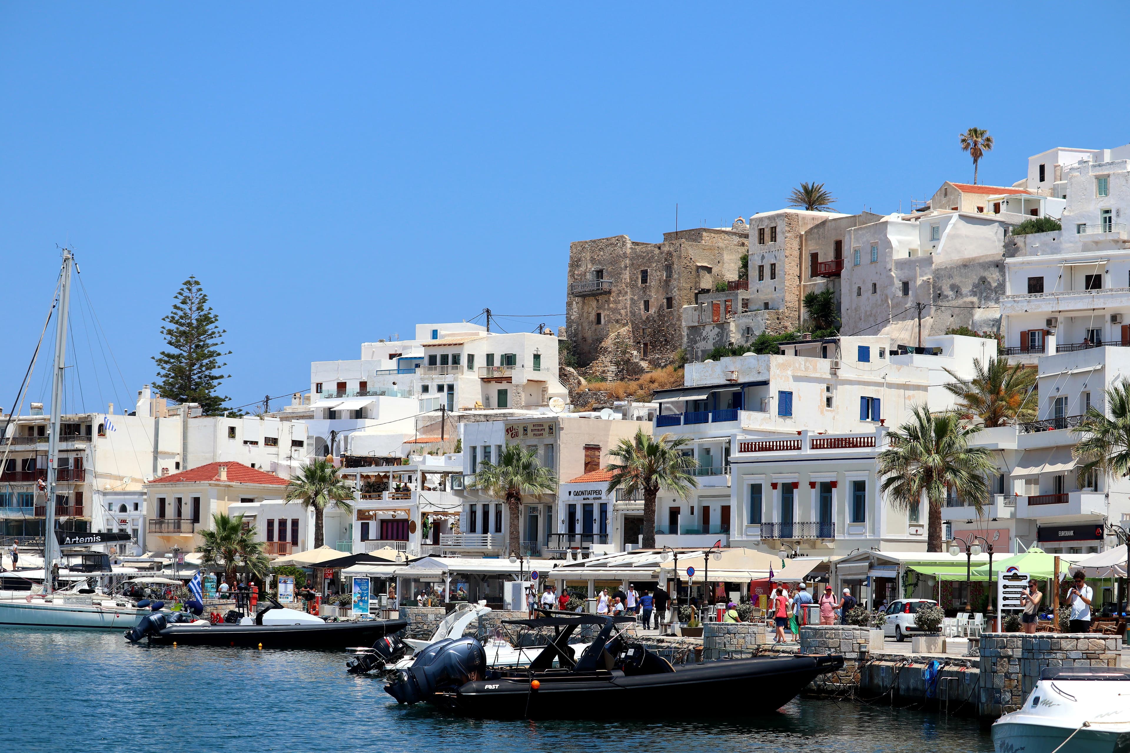 Naxos, Greece waterfront with white buildings and bougainvillea